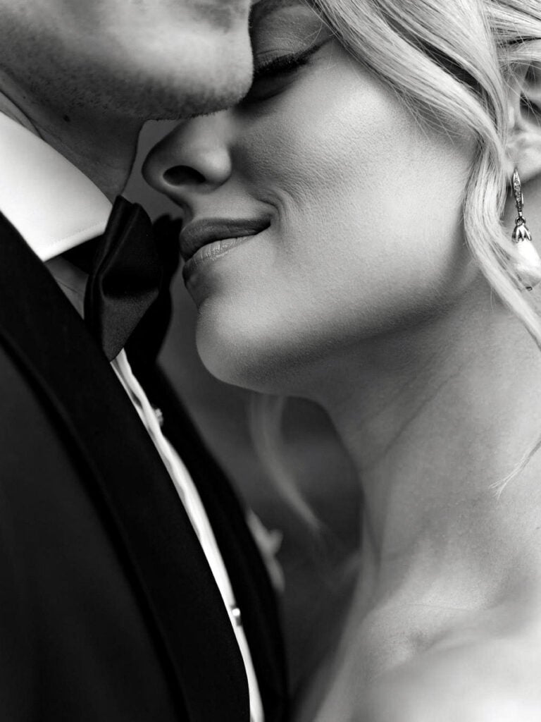 Bride and groom embracing in a black and white wedding portrait