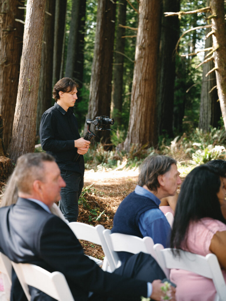 High-end wedding video production at an outdoor ceremony layout, showcasing venue space for vendors and natural ambient lighting