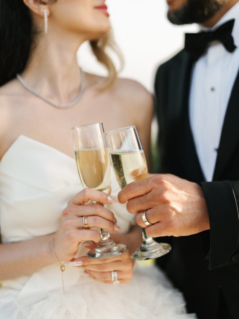Wedding couple toasting with champagne glasses during the reception toast