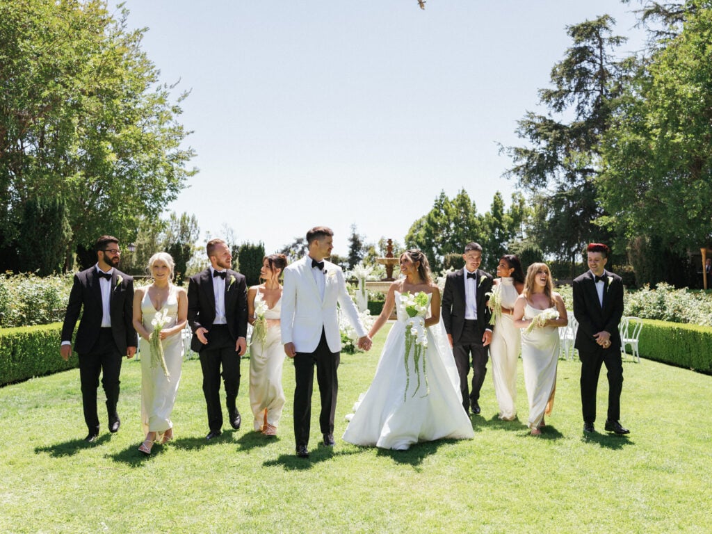 Bride and groom with guests during an outdoor wedding ceremony