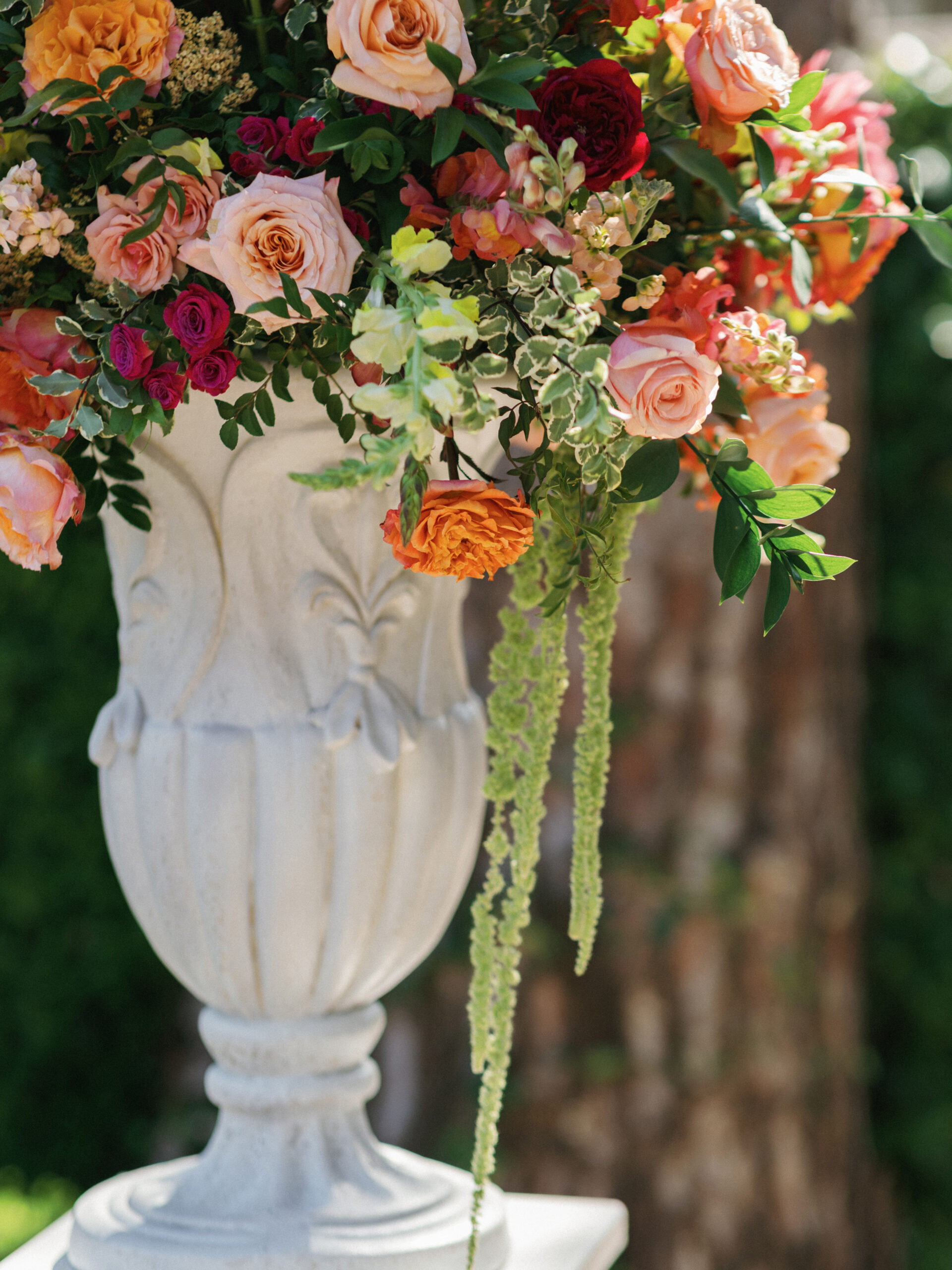 White floral arrangement in a stone urn