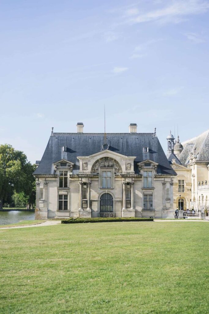 Chateau de Chantilly wedding venue exterior with classic French architecture, expansive green lawns, and historic palace grounds.