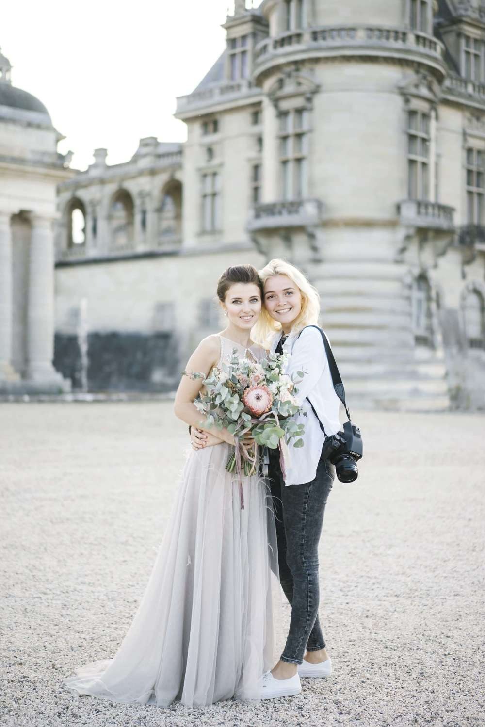 Bride and groom portrait in front of classic wedding architecture