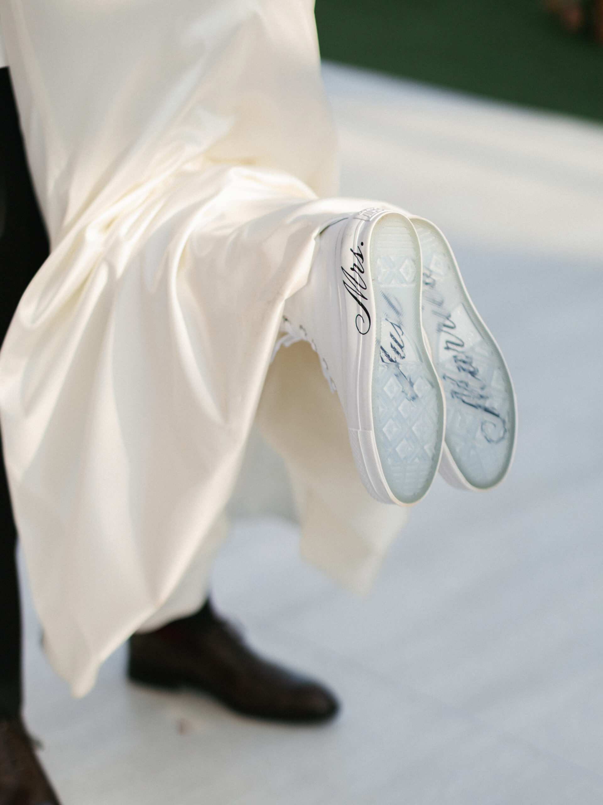 Bridal shoe and gown detail