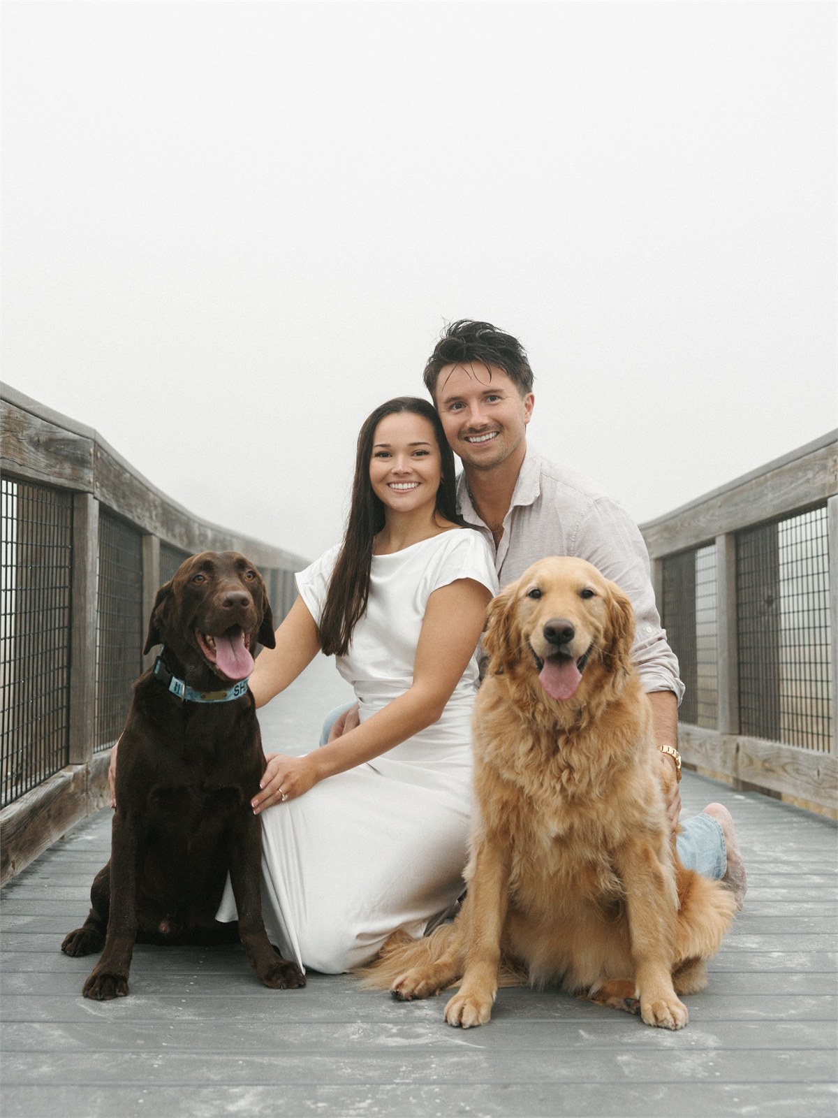 Couple seated with two dogs