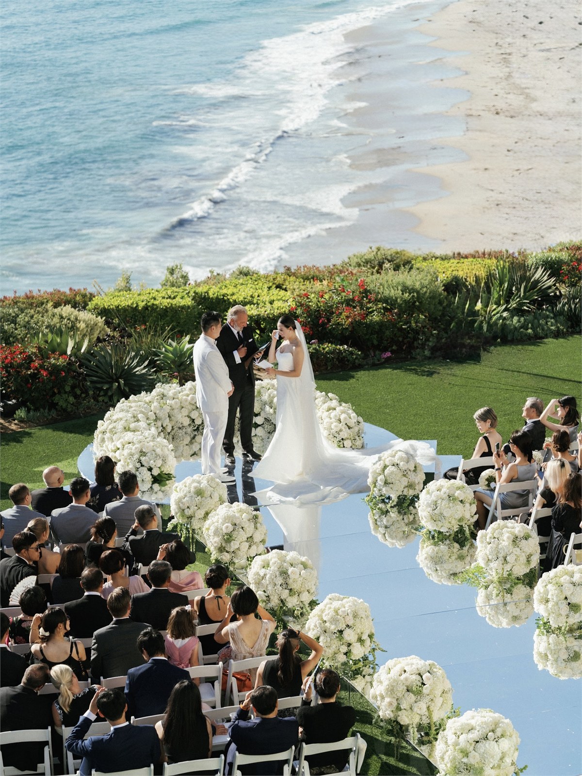 Couple standing together beside water during a ceremony