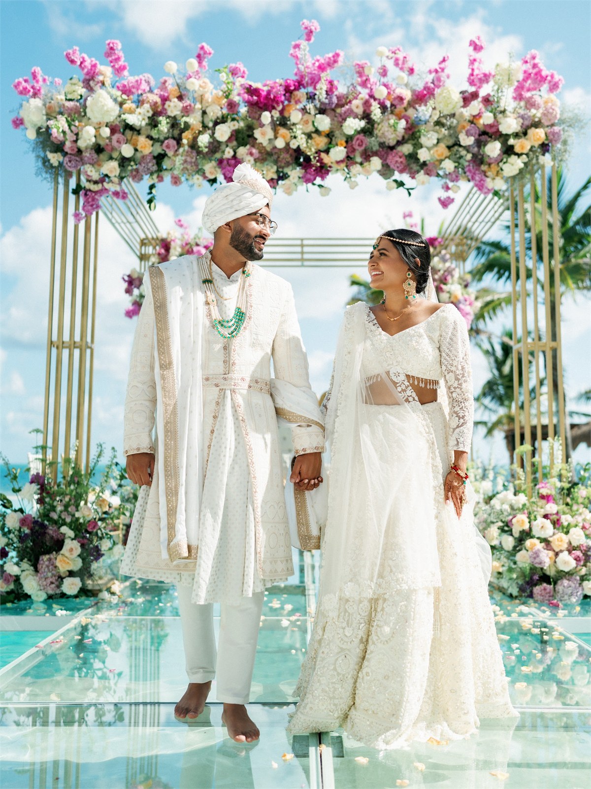 Couple standing together beside floral decorations