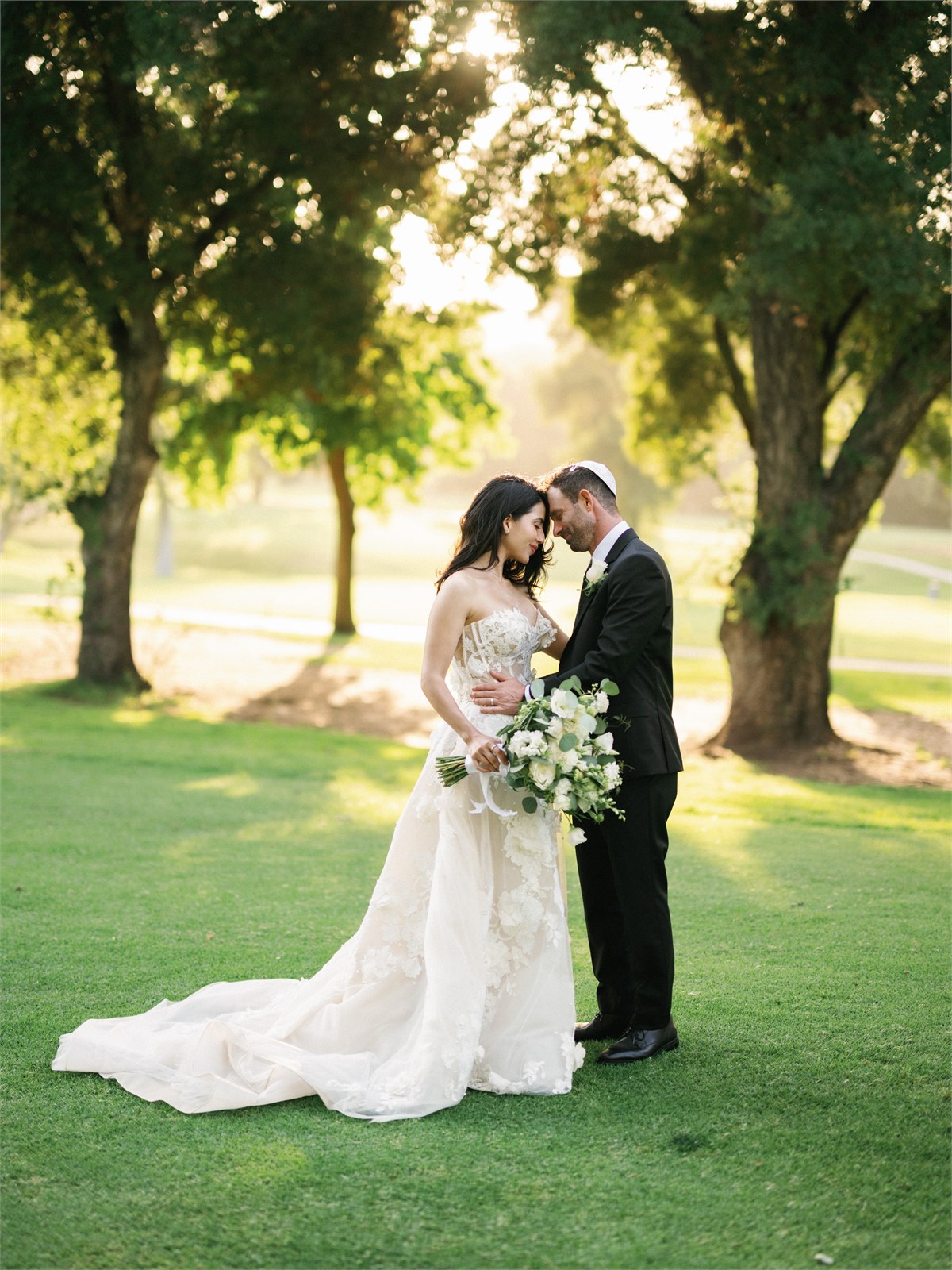 Wedding couple standing together outdoors