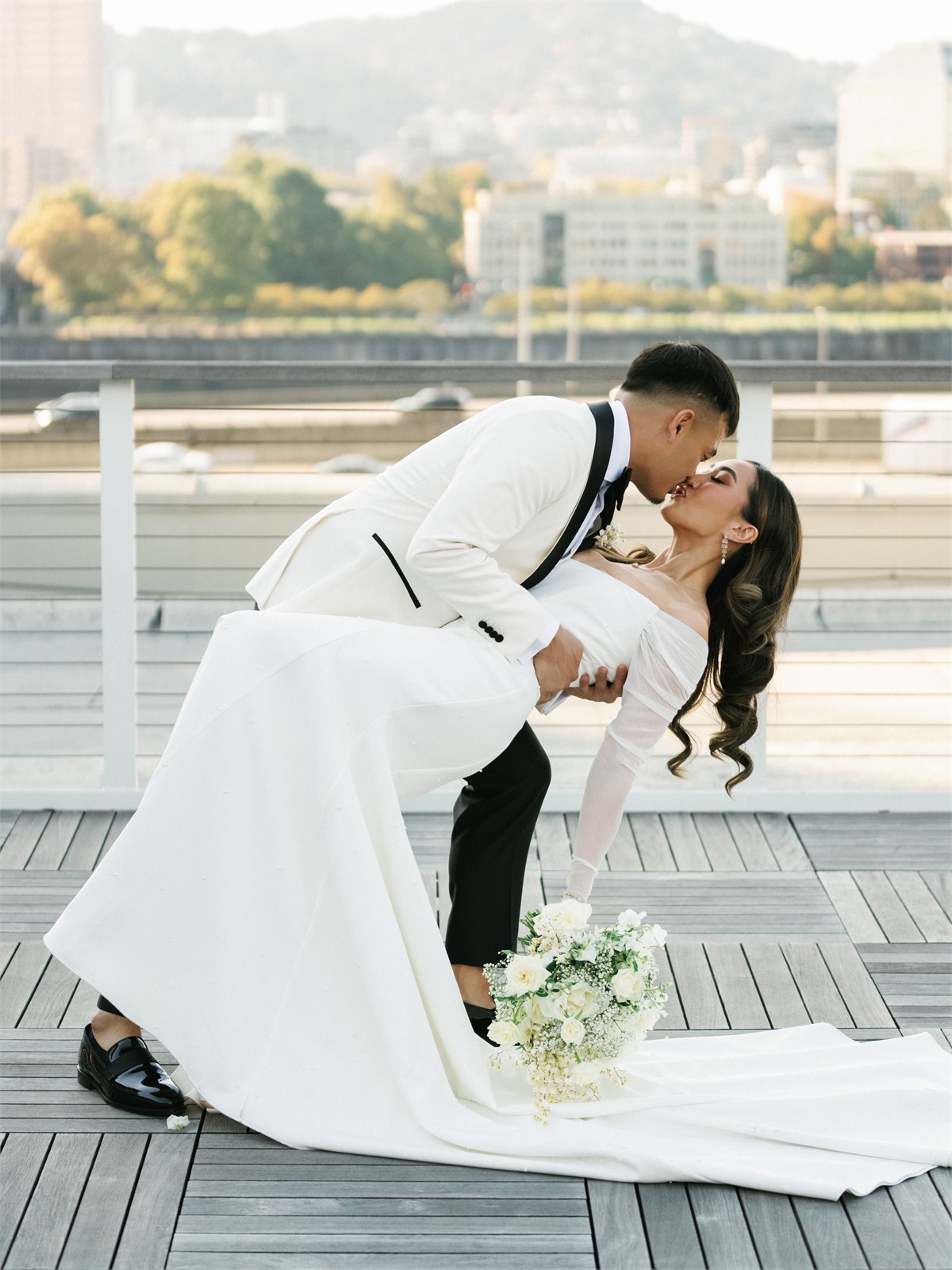 Wedding couple kissing beside water