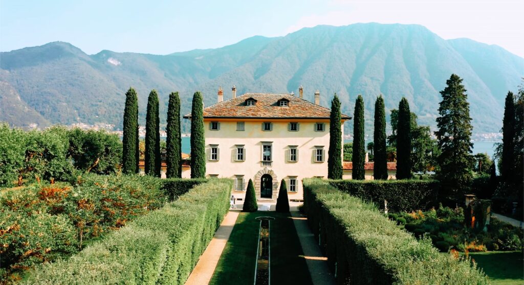 Aesthetic destination wedding venue featuring classic architecture with manicured gardens and scenic mountain views