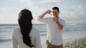 Professional wedding filmmaker evaluating scale and visual framing for a luxury seaside celebration under soft natural daylight.