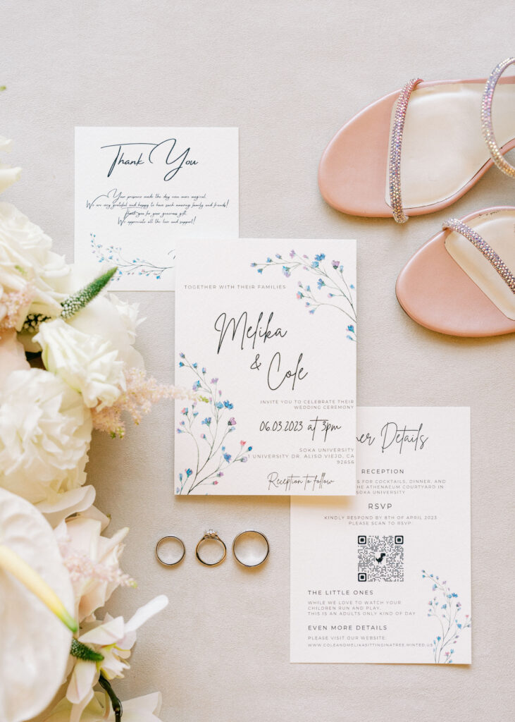 Modern wedding invitation suite with a QR code RSVP card, rose gold rhinestone strap sandals, and white wedding detail photos with three gold rings.
