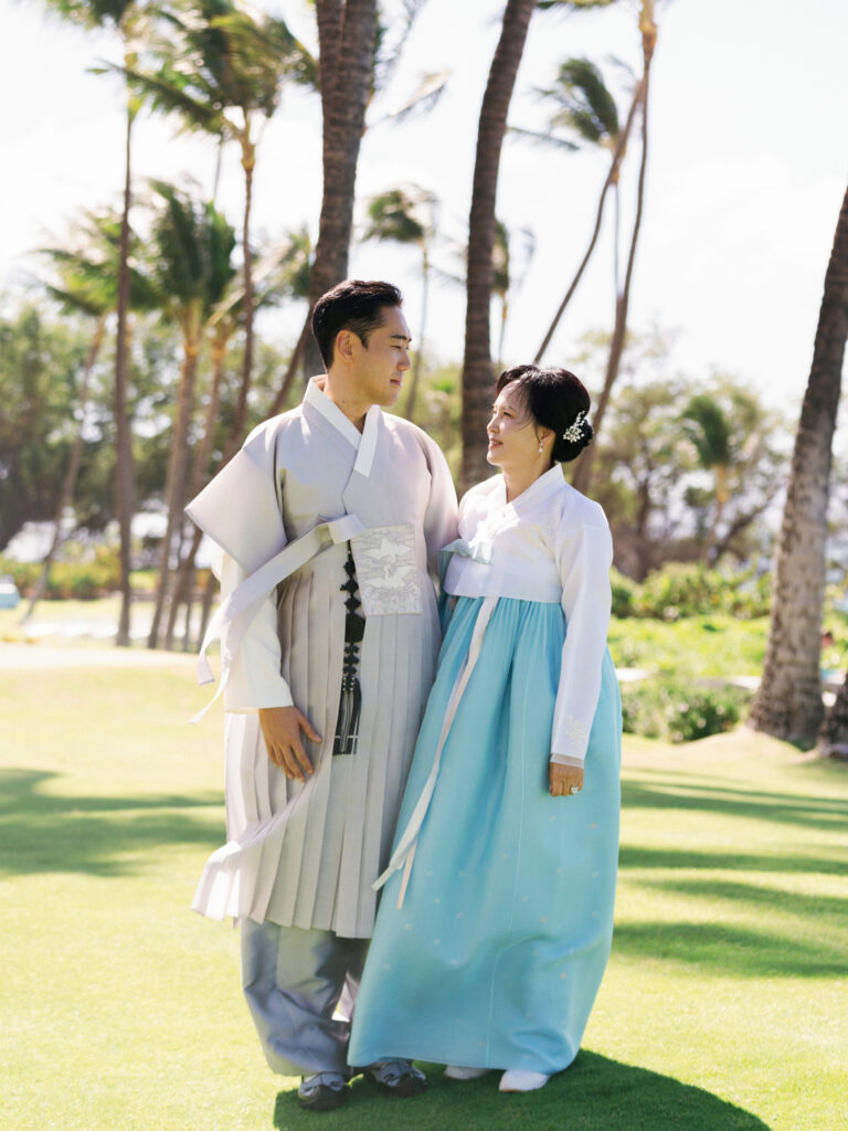 Editorial portrait of guests in traditional Korean Hanbok at a multicultural outdoor wedding.