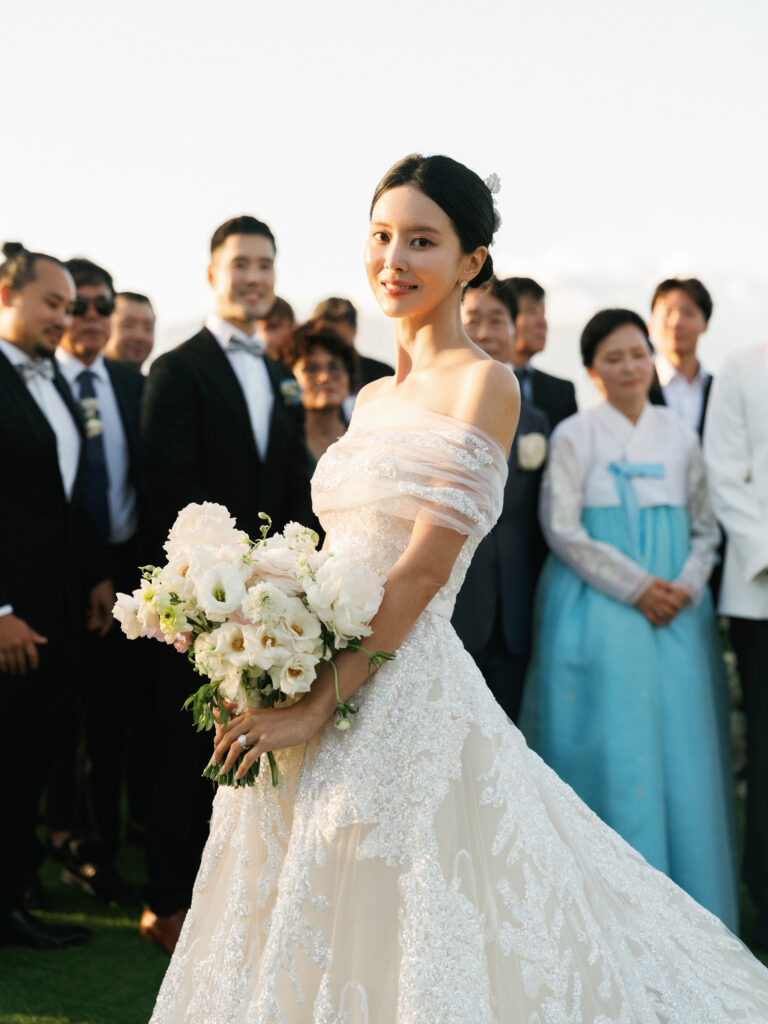 Vintage aesthetic wedding traditions featuring an elegant bride in an off-the-shoulder lace dress preparing for a bridal bouquet toss.