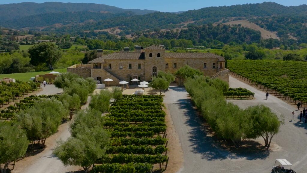 High-end California destination wedding venue at Sunstone Villa, featuring historic Tuscan architecture, stone facades, and manicured vineyard paths in Santa Ynez Valley.