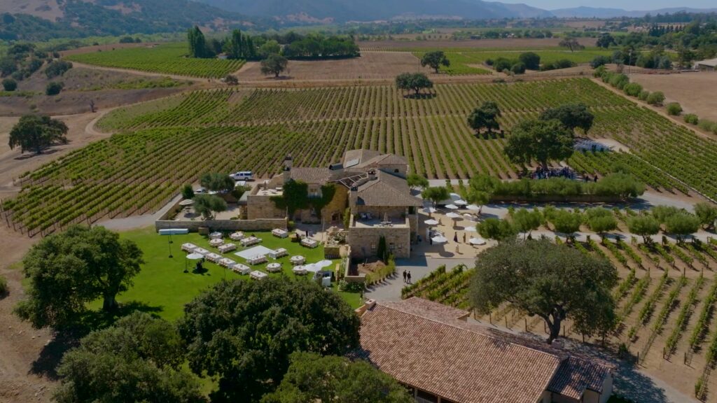 Luxury private estate wedding coordination at Sunstone Winery, showcasing an exclusive villa property layout with an outdoor reception setup surrounded by rolling California hills.