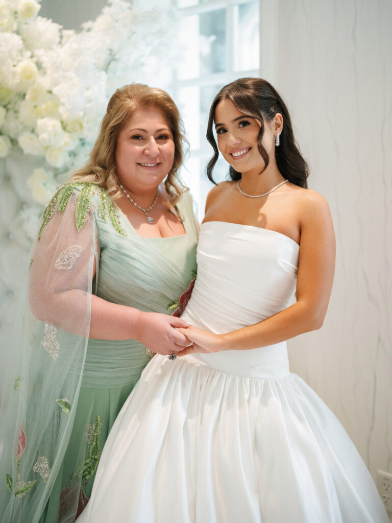 Editorial bride and mother portrait, capturing high-end wedding fashion with a timeless satin bridal dress and a sophisticated embroidered mother's gown.