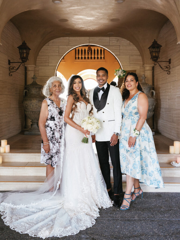 Classic luxury wedding family photos, sophisticated newlyweds with parents at an upscale private estate venue, timeless wedding editorial style.