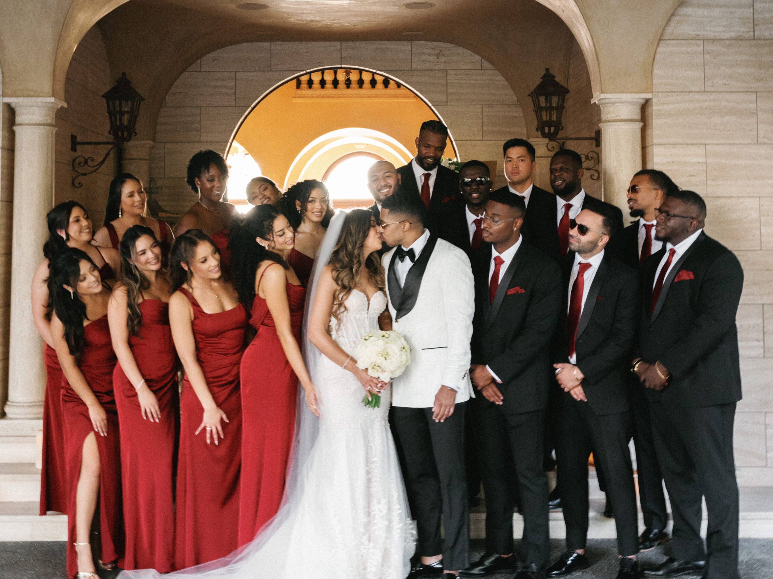 Bride and groom posing with friends, elegant wedding party style inspiration with red wine bridesmaids attire, editorial wedding photography.