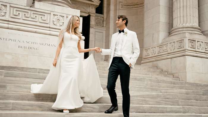 Newlyweds walking together on stone steps