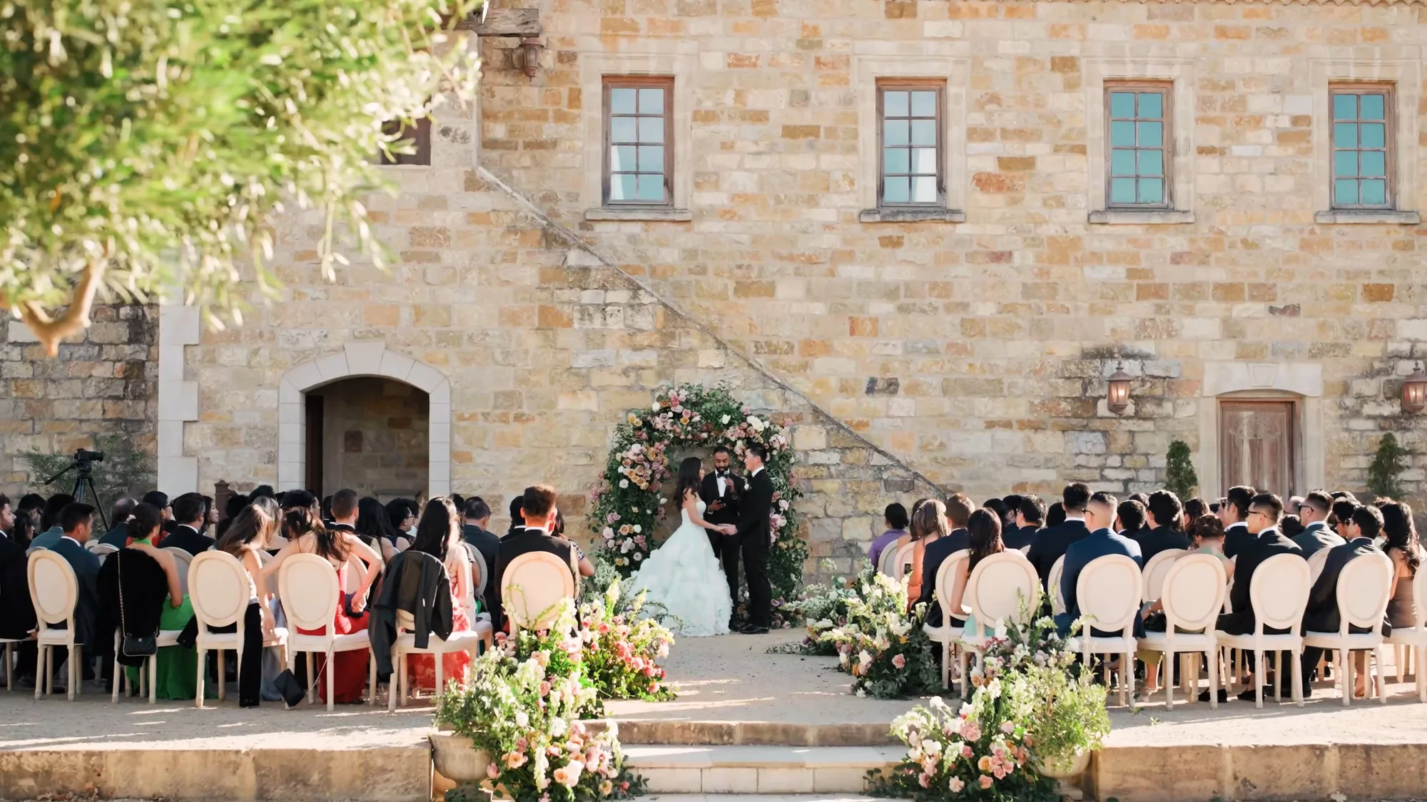 Outdoor wedding ceremony in a courtyard at a stone estate
