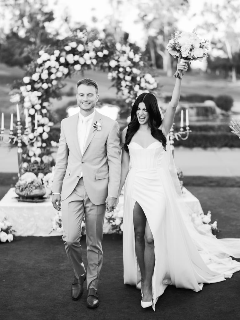 Couple walking together in a black-and-white ceremony photograph