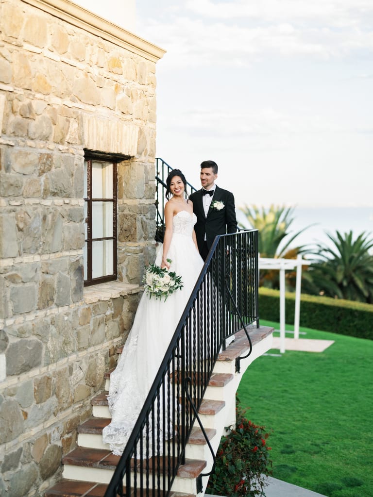 Couple walking on garden steps at a wedding venue