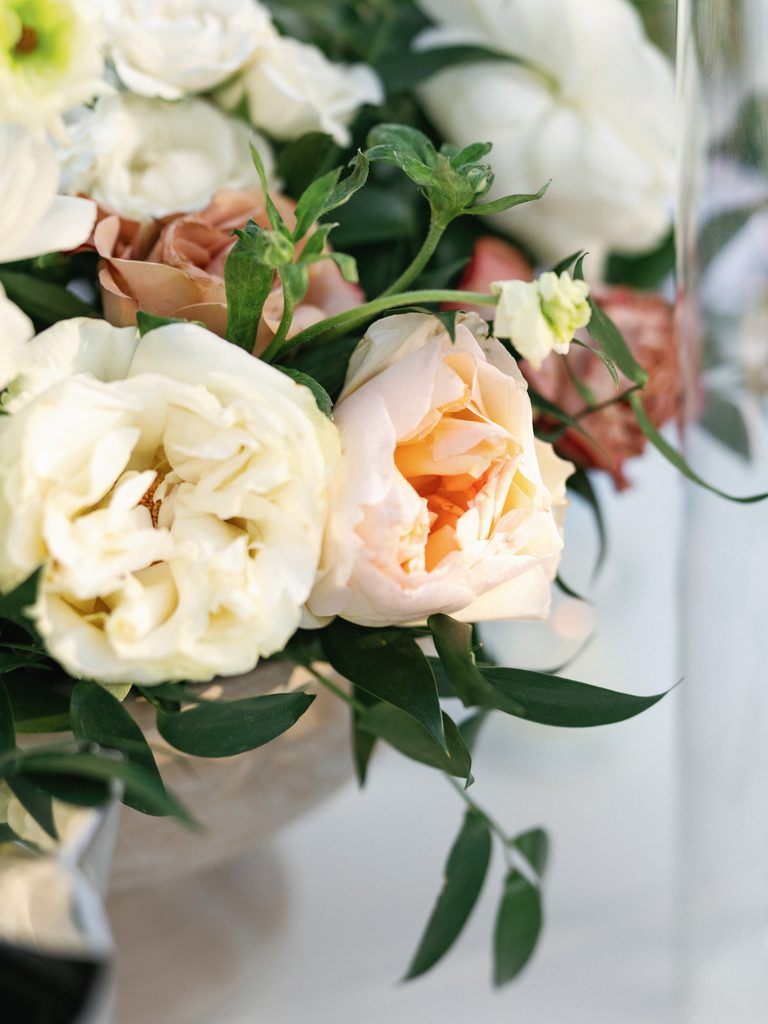 Close-up wedding reception photos of a luxury floral centerpiece with blush and white roses.