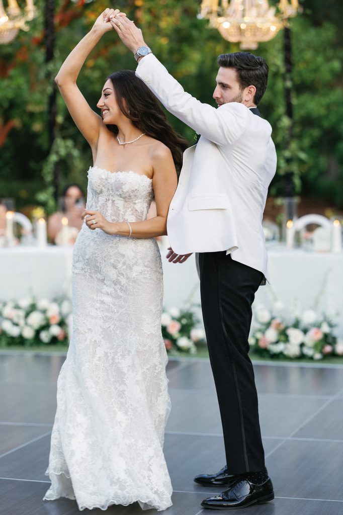 Newlyweds share an elegant first dance captured in timeless wedding reception photos