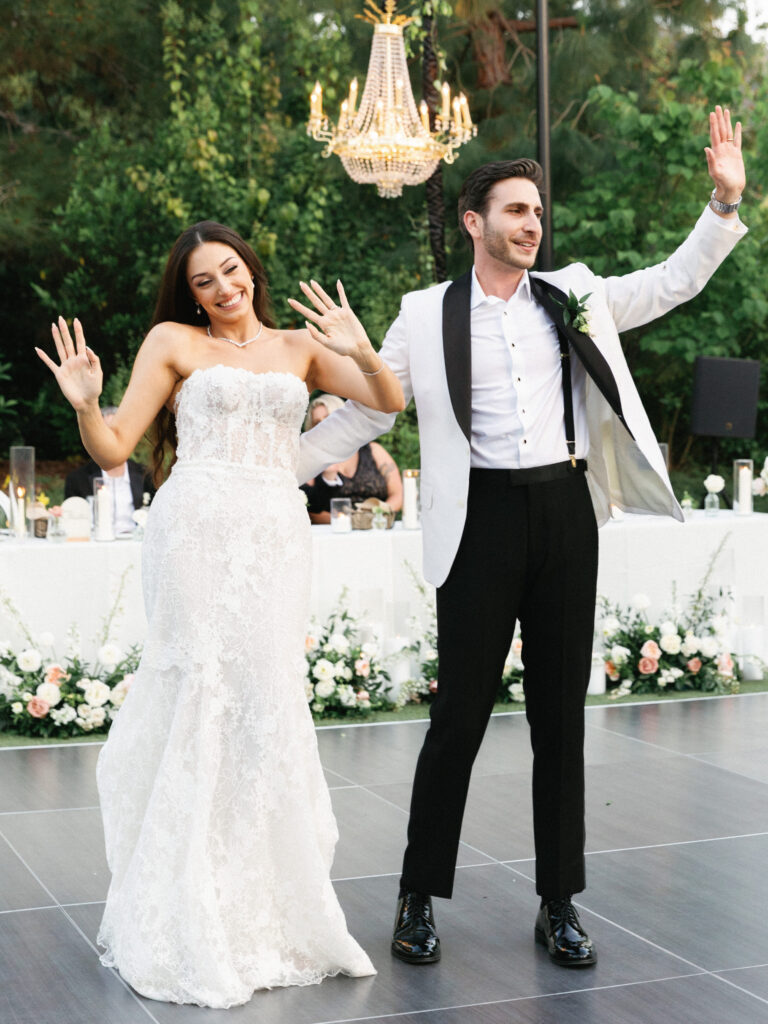 Bride and groom wave excitedly during their grand entrance in these dynamic wedding reception photos.
