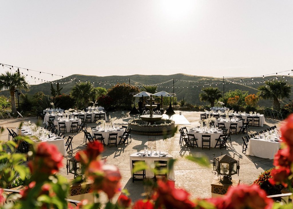 Luxury wedding reception layout with round tables around a fountain at Hummingbird Nest Ranch