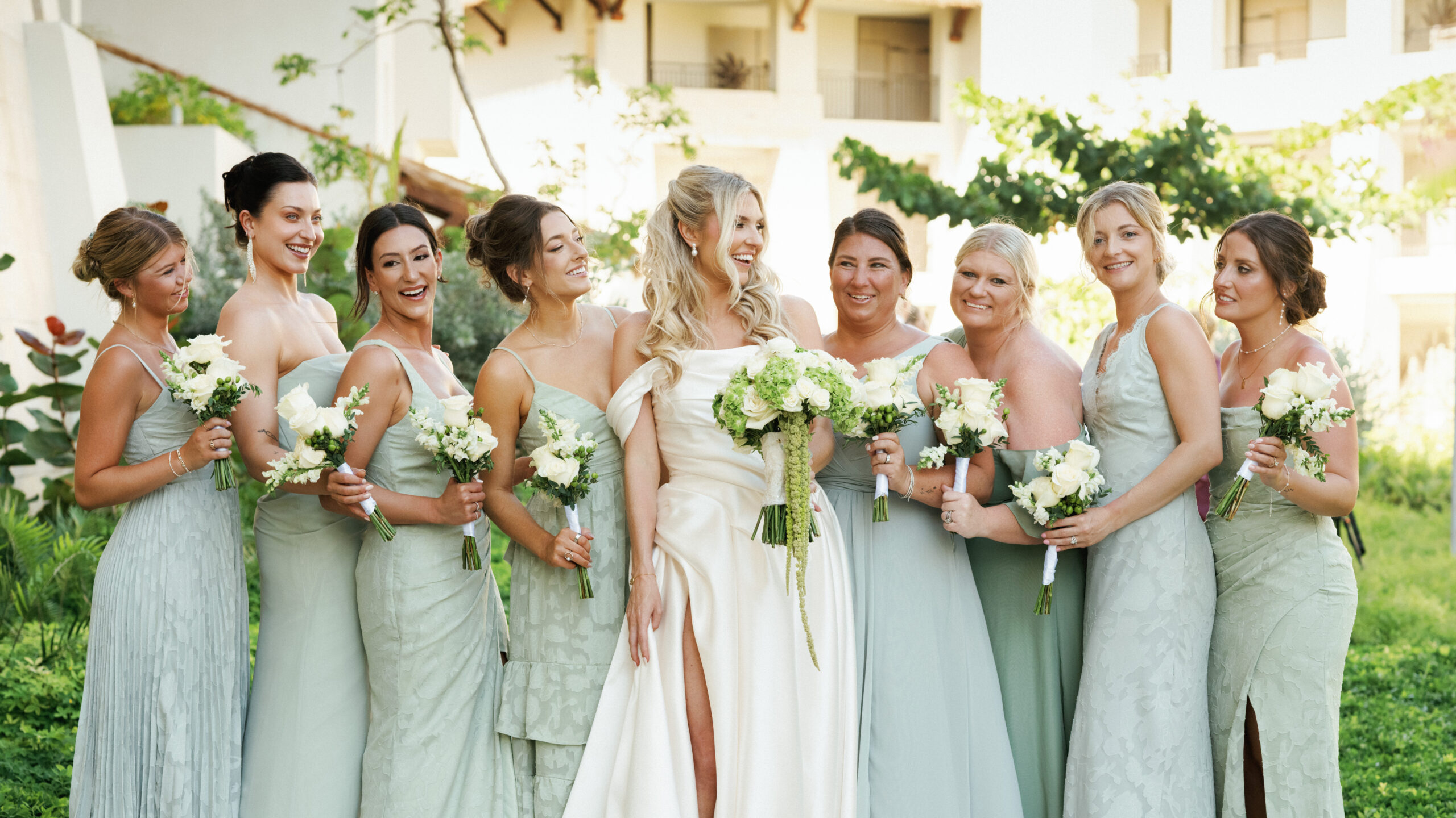 Premium tropical resort wedding party styling with elegant white rose bouquets