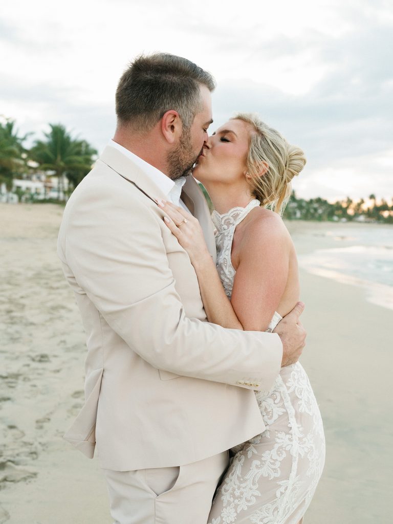 Romantic oceanfront embrace helps couples choose a destination wedding photographer for beach events