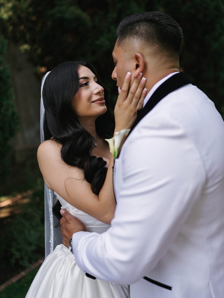 Intimate luxury wedding portraits showing genuine connection between newlyweds outdoors