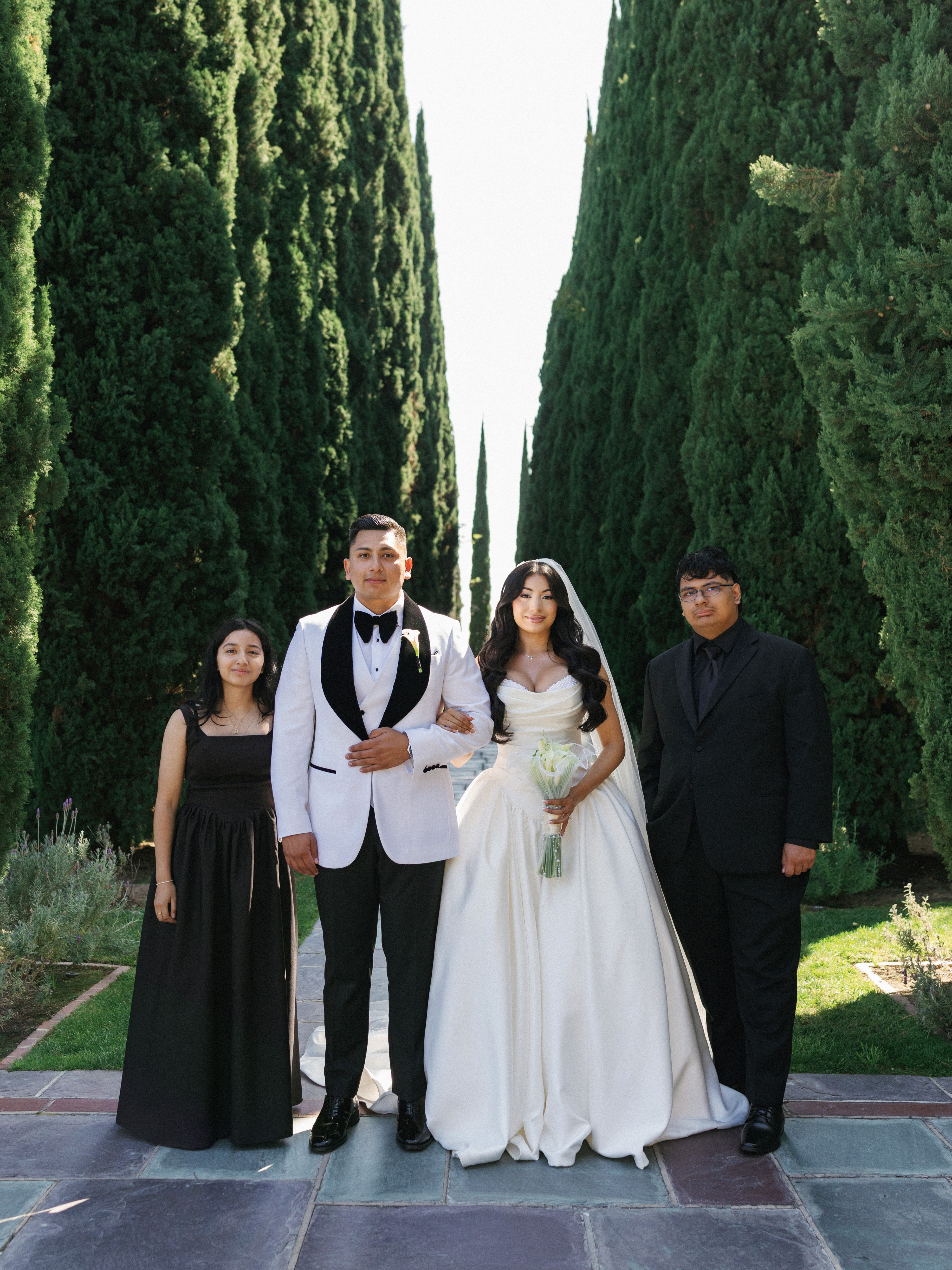 Elegant family formal wedding portraits on a beautiful garden pathway