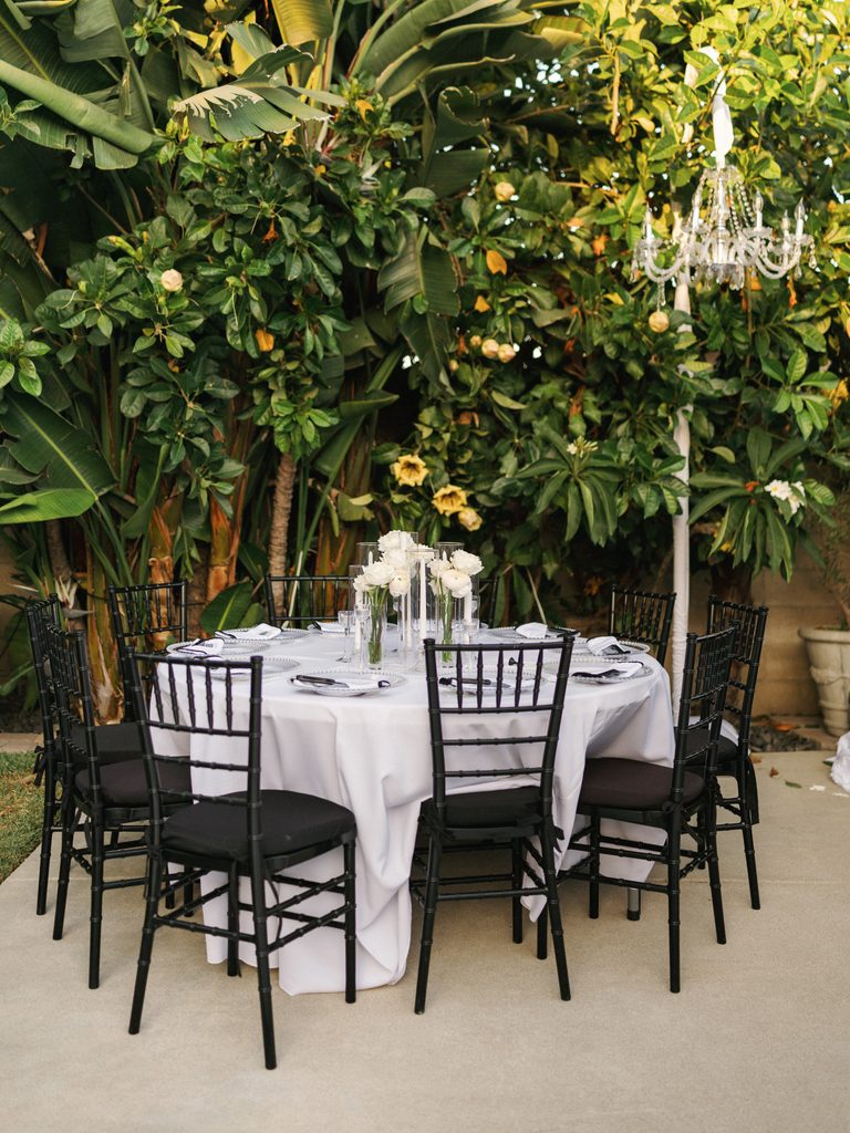 Glamorous destination wedding dinner decor under a crystal chandelier display