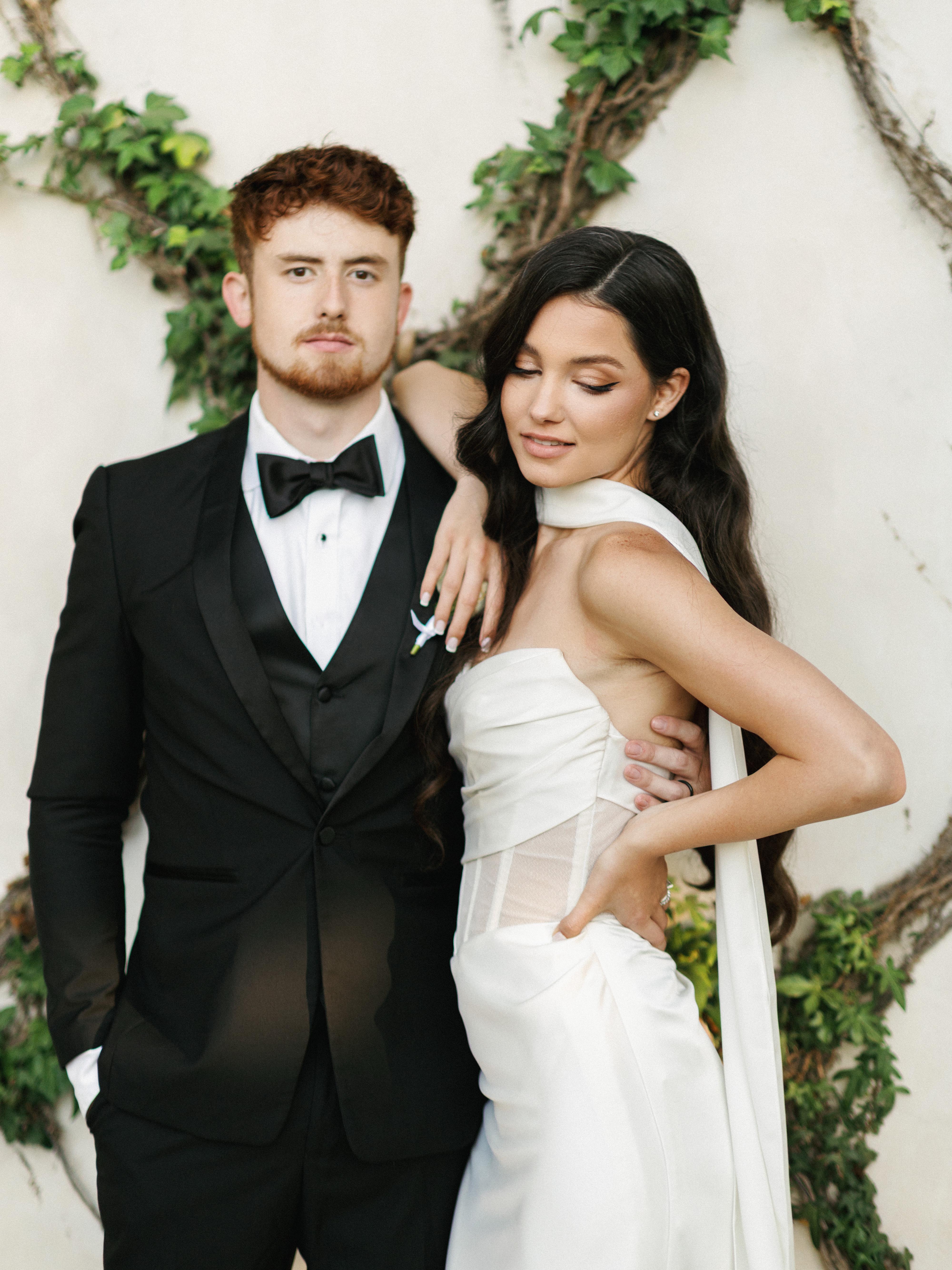 Trendy luxury couple in formal attire posing outdoors, helping modern brides choose aesthetic options within premium wedding photography styles.