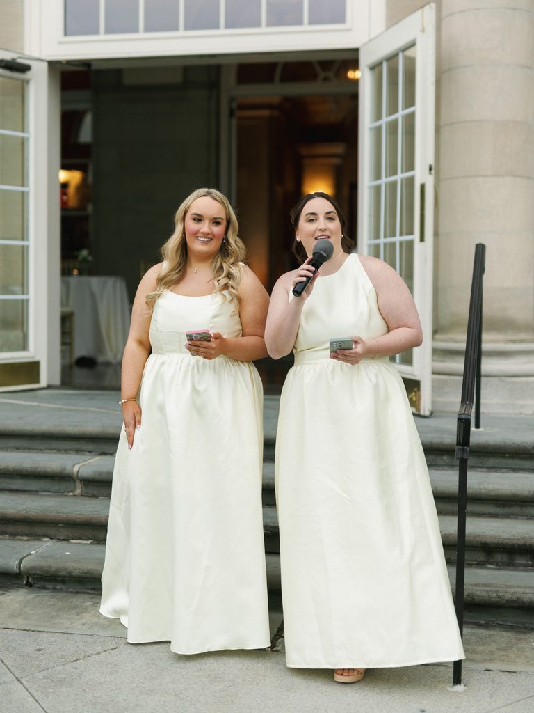 Maid of honor giving a toast during an upscale outdoor wedding reception celebration.