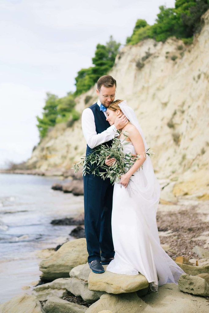Coastal portraits on rocky shores show how an expert destination wedding photographer uses nature