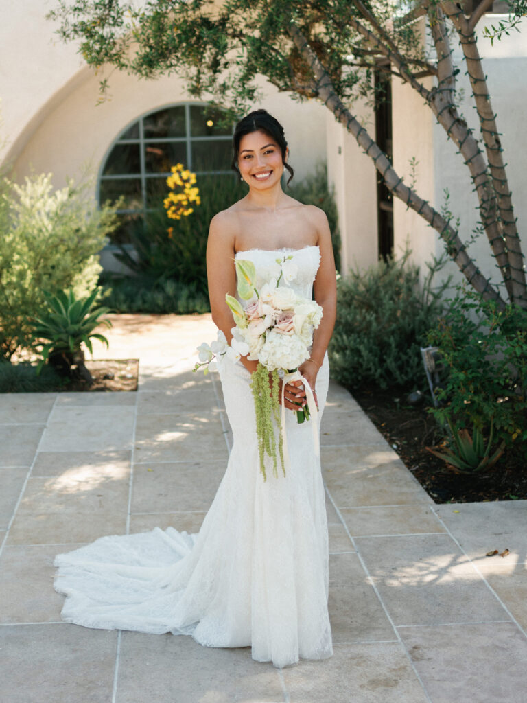 Full length bridal portrait session featuring an elegant white orchid cascade bouquet