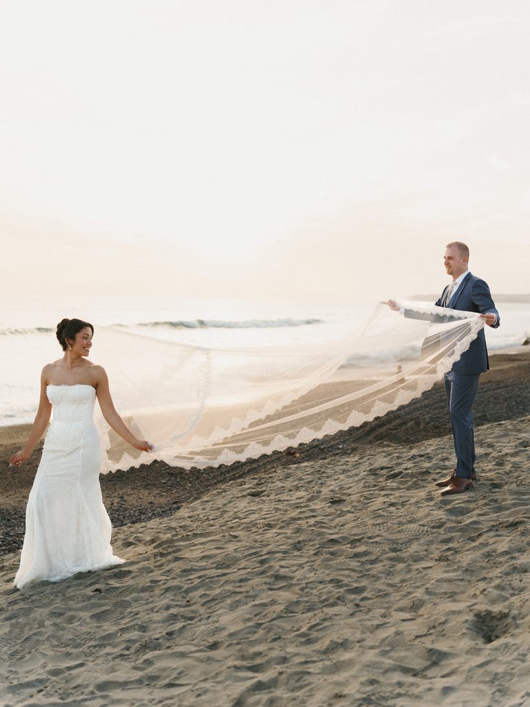 Creative beach wedding photo ideas showcasing a stunning cathedral veil with trim