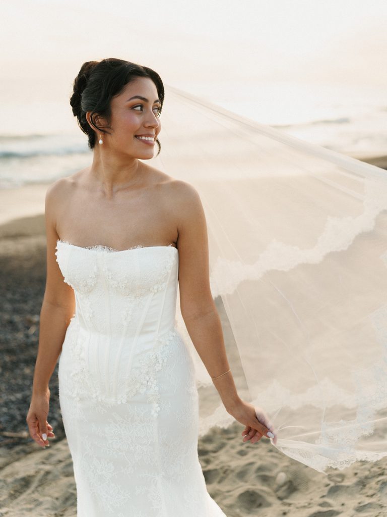Elegant strapless corset gown look during a scenic beachfront wedding photoshoot