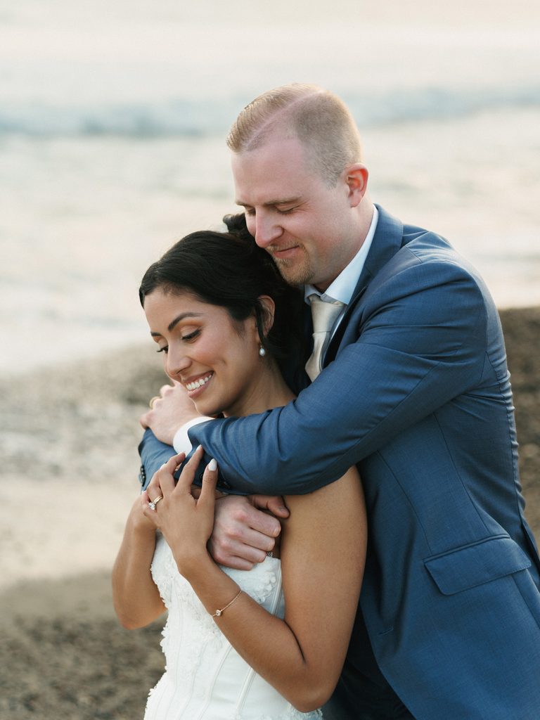 Close up couple portrait featuring a strapless corset dress and a blue suit