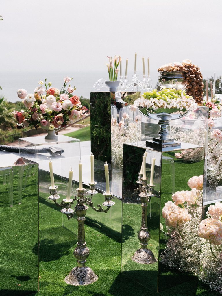 Luxury mirrored pedestals with elegant floral centerpieces and silver candelabras are featured in these wedding ceremony photos