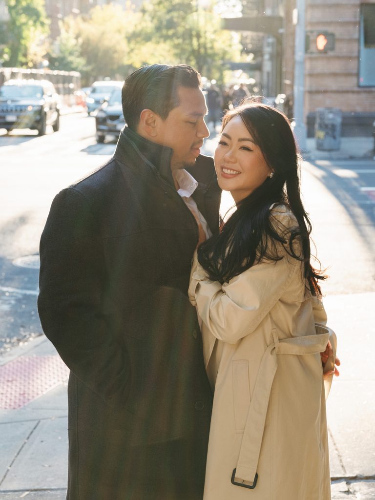City street couple portrait with golden hour sun flare, inspiring urban engagement photo ideas.