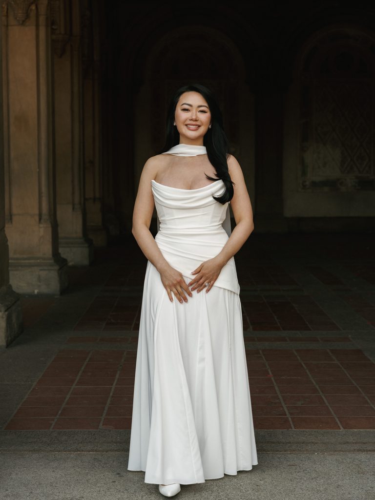 Full length bridal portrait inside a historic stone pavilion inspiring high end engagement photo ideas