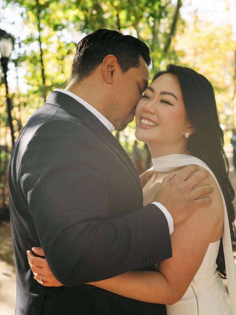 Close up portrait under green trees in Central Park inspiring iconic New York engagement photo ideas