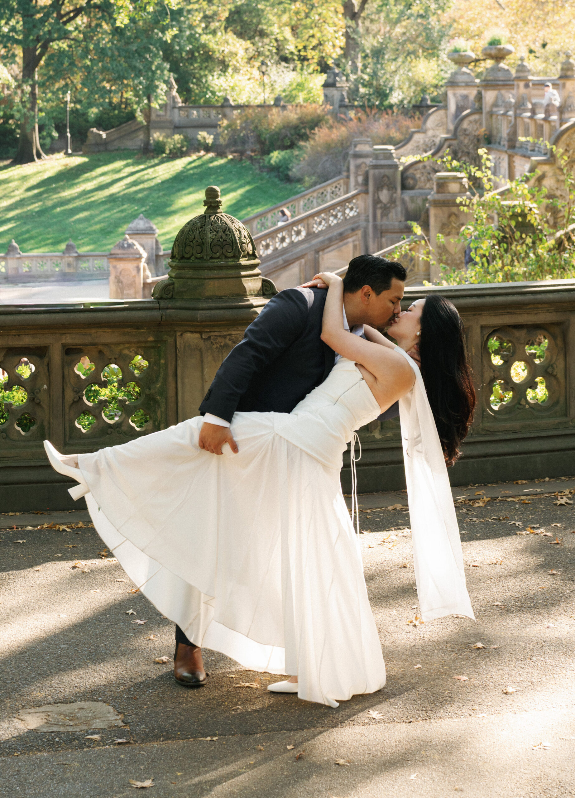 Romantic dip kiss pose at Bethesda Terrace inspiring classic luxury engagement photo ideas
