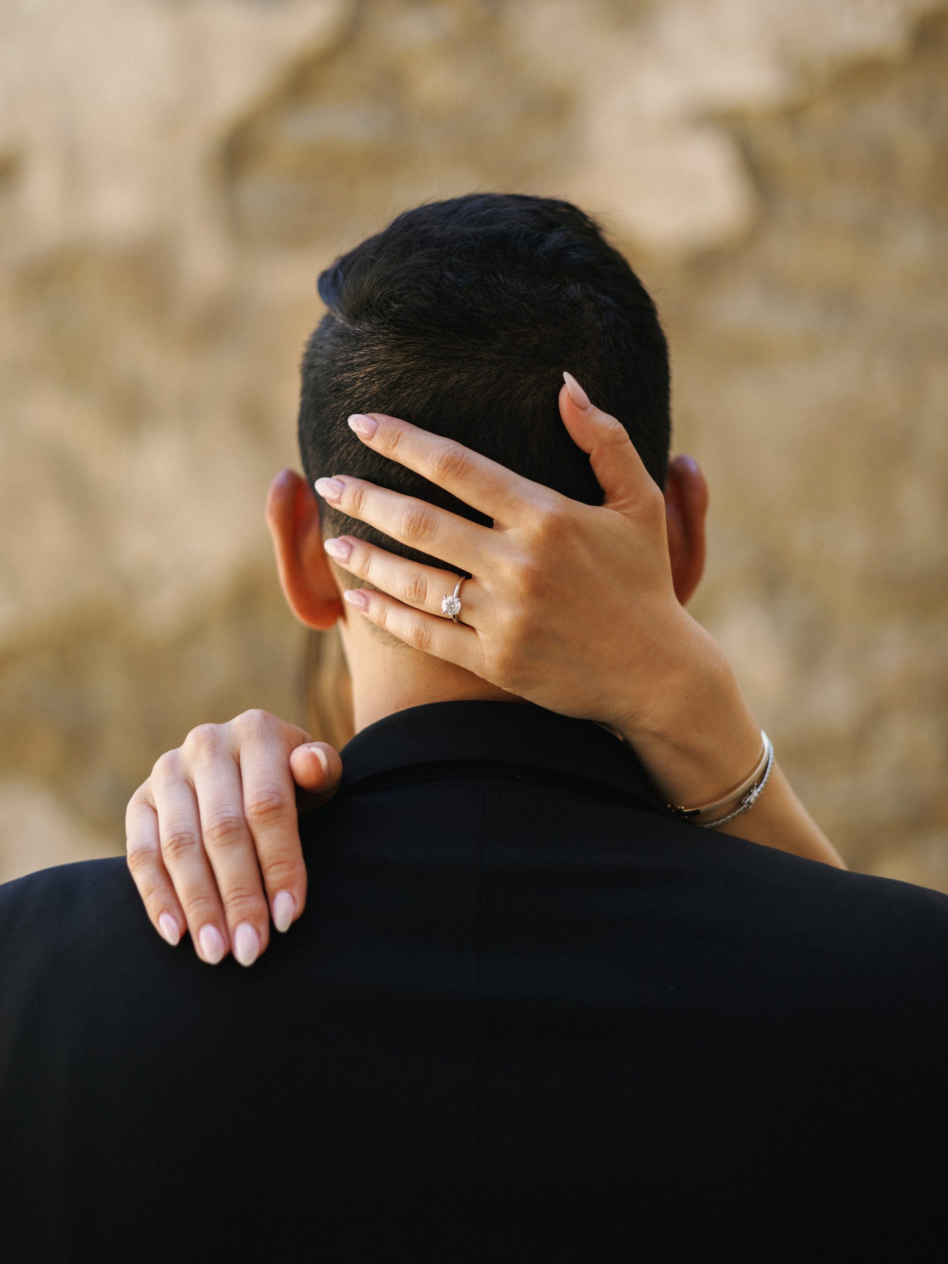 Close-up of a diamond ring and elegant bracelet, highlighting jewelry details for engagement photo outfits.