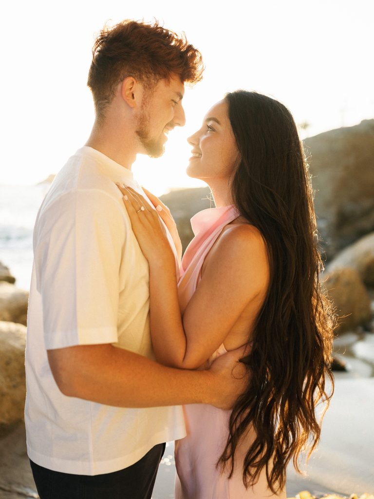 Close-up sunset portrait highlighting a pink satin dress, perfect for romantic engagement photo outfits.